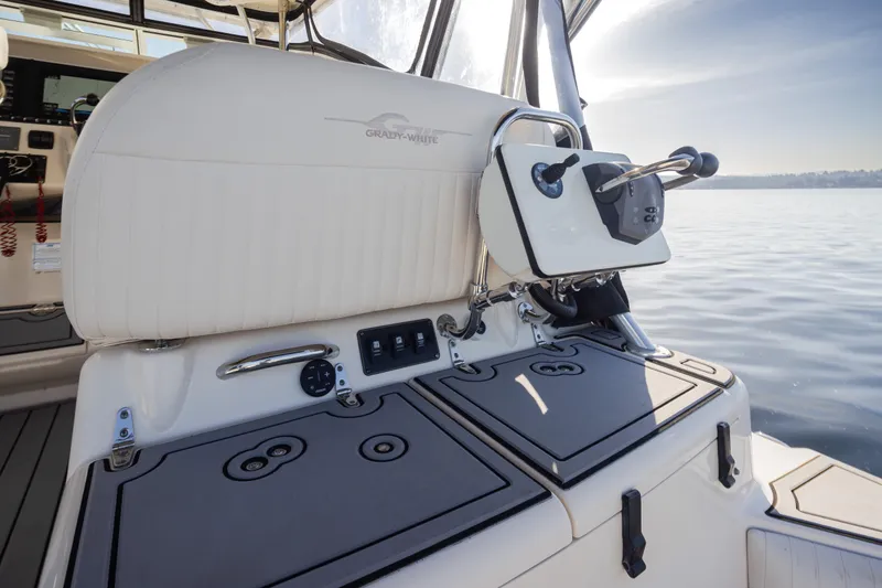Slide: The Image of 2006 Grady-White Express 360 boat interior with helm controls and seating, on calm water. - 36