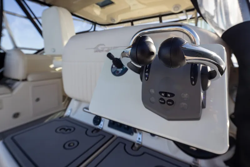 Slide: The Image of 2006 Grady-White Express 360 boat controls, featuring dual throttle levers and modern dashboard. - 37