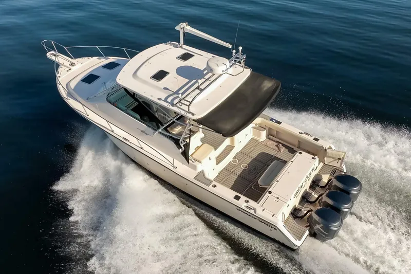 Slide: The Image of 2006 Grady-White Express 360 boat cruising on open water, rear view. - 4