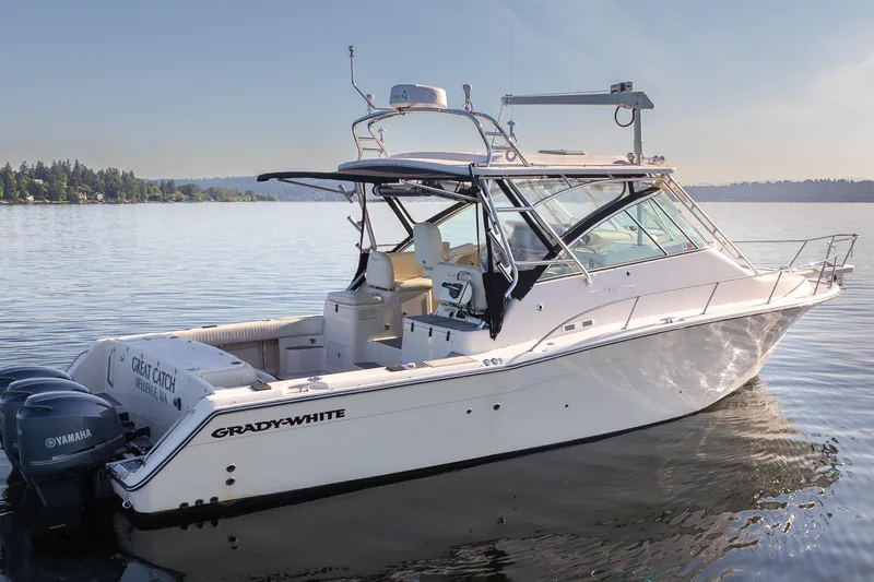 Slide: The Image of 2006 Grady-White Express 360 boat on calm water, featuring Yamaha engines. - 5