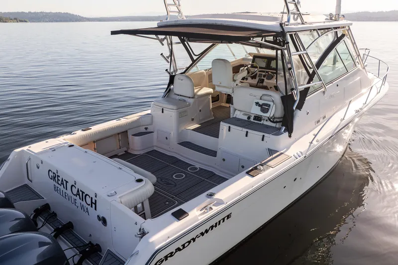 Slide: The Image of 2006 Grady-White Express 360 boat on calm water, featuring spacious deck and modern design. - 7
