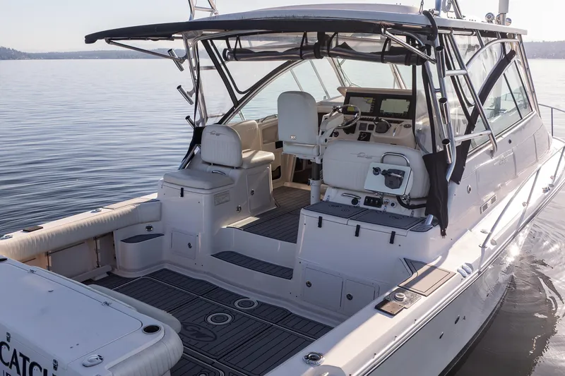 Slide: The Image of 2006 Grady-White Express 360 boat with spacious cockpit and modern helm on calm water. - 9