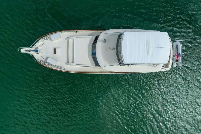 Slide: The Image of Overhead view of a 1978 Hatteras 53 Yacht Fisherman on calm green water. - 10