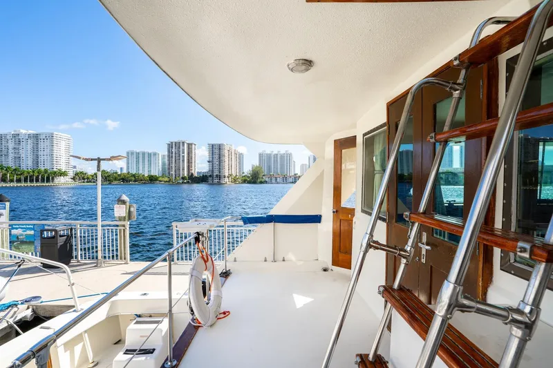 Slide: The Image of 1978 Hatteras 53 Yacht Fisherman docked with city skyline view. - 35