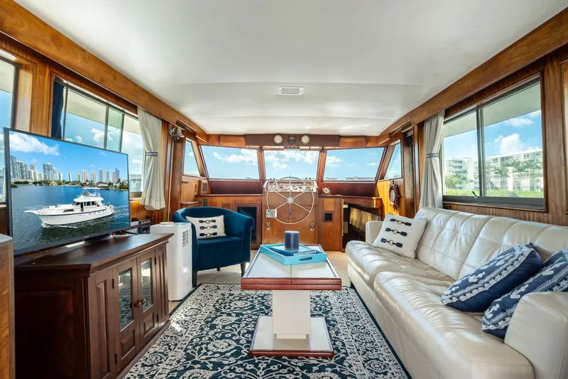 Slide: The Image of Interior of a 1978 Hatteras 53 Yacht Fisherman with elegant furnishings and large windows. - 46
