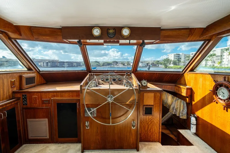 Slide: The Image of 1978 Hatteras 53 Yacht Fisherman helm with wooden interior and panoramic windows. - 49