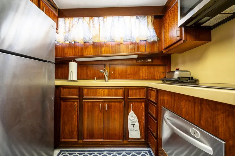 Slide: The Image of 1978 Hatteras 53 Yacht Fisherman kitchen with wood cabinets and stainless steel appliances. - 56