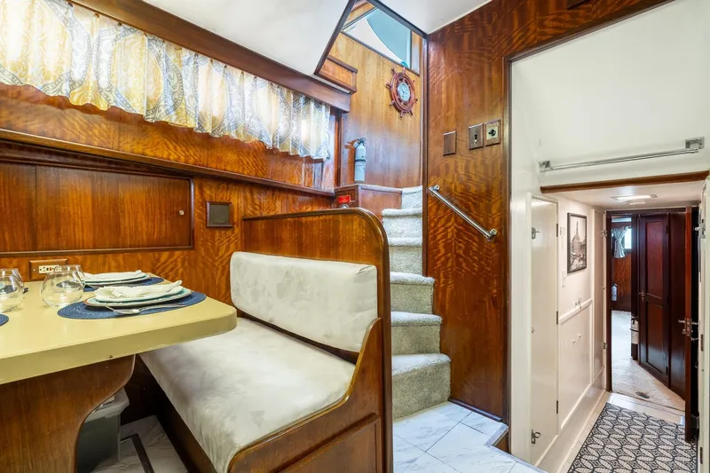 Slide: The Image of Interior of 1978 Hatteras 53 Yacht Fisherman with dining area and staircase. - 57