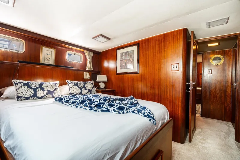 Slide: The Image of Luxurious 1978 Hatteras 53 Yacht Fisherman bedroom with elegant wood paneling and nautical decor. - 65