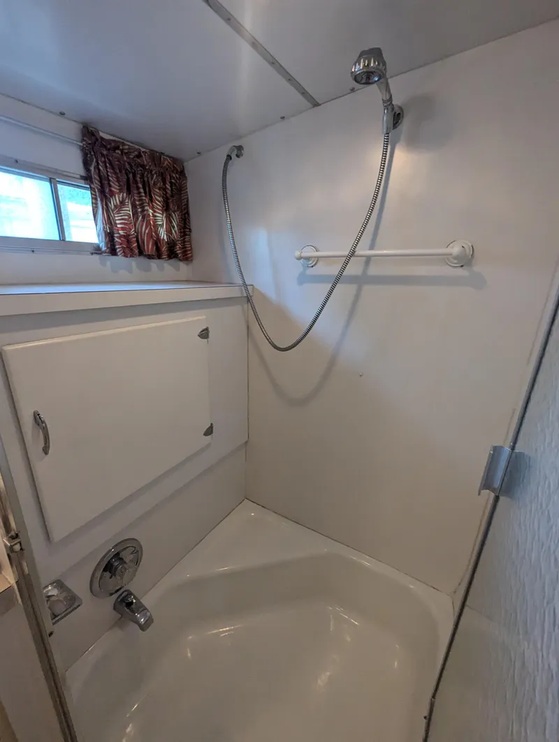 Slide: The Image of Shower area in a 1965 Pacemaker 53 Motor Yacht, featuring a handheld showerhead. - 13