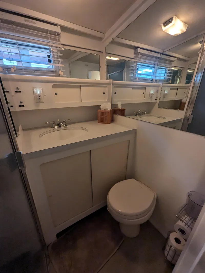 Slide: The Image of Bathroom interior of 1965 Pacemaker 53 Motor Yacht with sink, mirror, and toilet. - 19