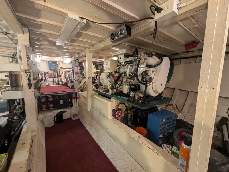 Slide: The Image of Engine room of a 1965 Pacemaker 53 Motor Yacht, showcasing machinery and control panels. - 20