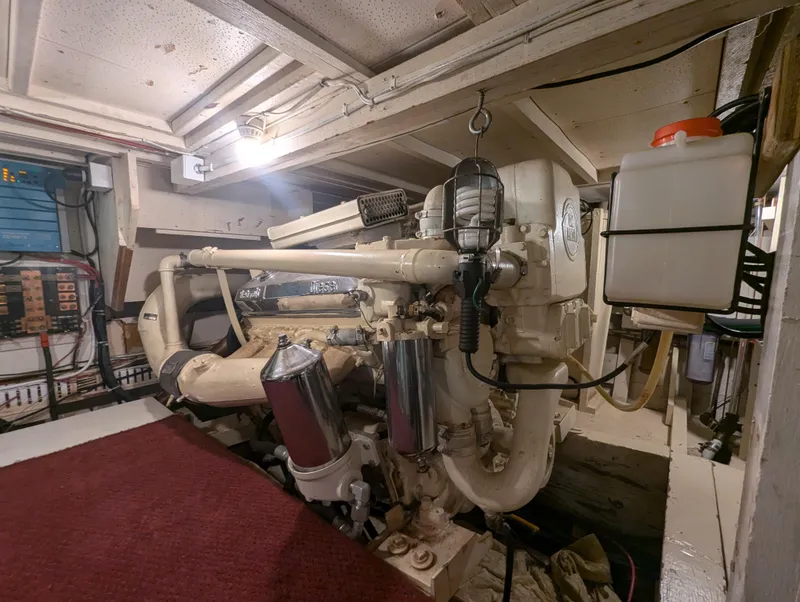 Slide: The Image of Engine room of a 1965 Pacemaker 53 Motor Yacht, showcasing mechanical components and equipment. - 21