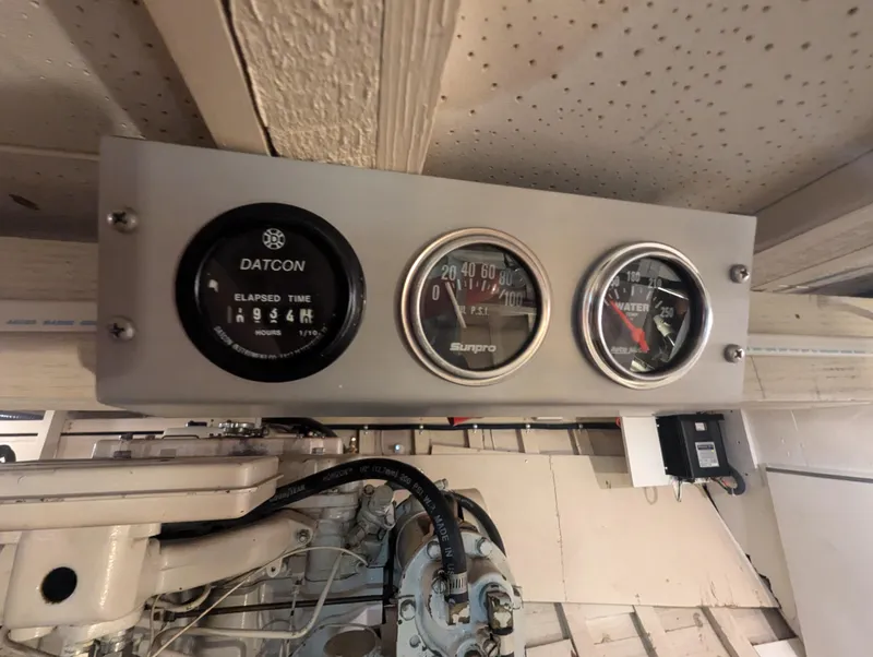 Slide: The Image of Instrument panel on 1965 Pacemaker 53 Motor Yacht, featuring gauges for elapsed time and water temperature. - 22
