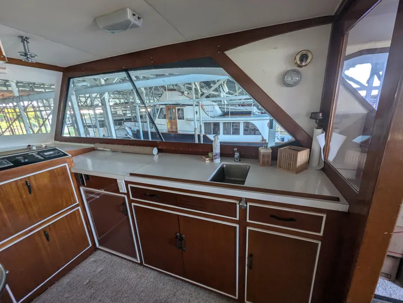 Slide: The Image of Interior of 1965 Pacemaker 53 Motor Yacht with wooden cabinetry and large windows. - 25