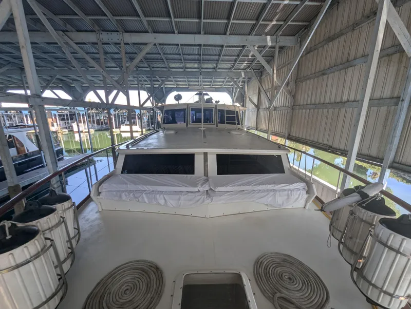 Slide: The Image of 1965 Pacemaker 53 Motor Yacht docked in covered marina, showcasing spacious deck. - 27
