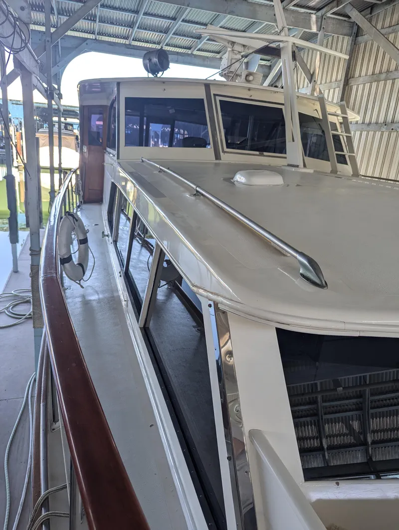 Slide: The Image of 1965 Pacemaker 53 Motor Yacht in a covered dock, showcasing classic design and structure. - 28
