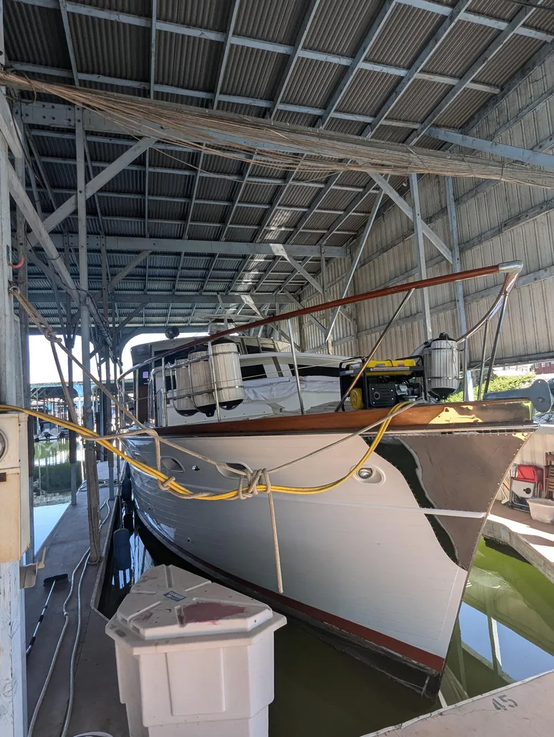 Slide: The Image of 1965 Pacemaker 53 Motor Yacht docked in a covered marina. - 29