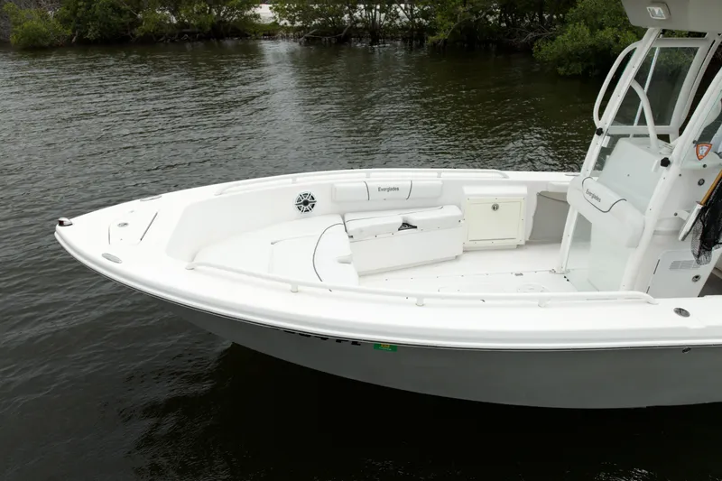 Slide: The Image of 2007 Everglades 243 Center Console boat on calm water, featuring sleek white design. - 14