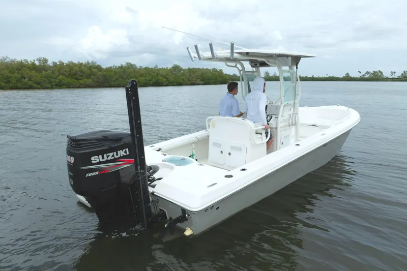 Slide: The Image of 2007 Everglades 243 Center Console boat on water with Suzuki engine. - 2