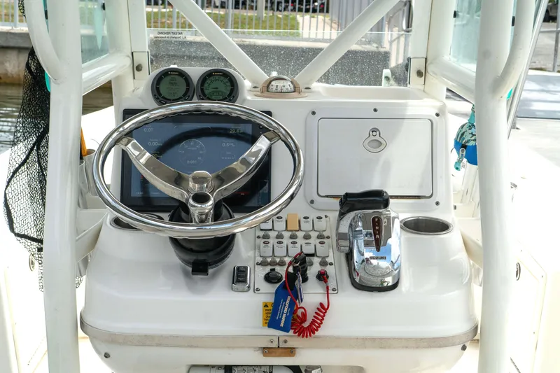 Slide: The Image of 2007 Everglades 243 Center Console boat dashboard with steering wheel and controls. - 20