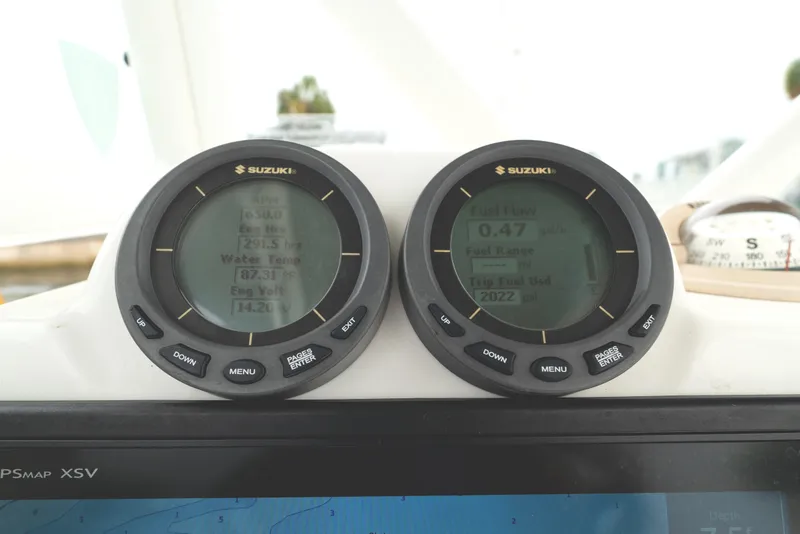 Slide: The Image of Suzuki gauges on 2007 Everglades 243 Center Console boat dashboard, displaying engine data. - 22