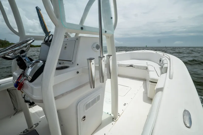 Slide: The Image of 2007 Everglades 243 Center Console boat on open water, showcasing helm and seating area. - 24