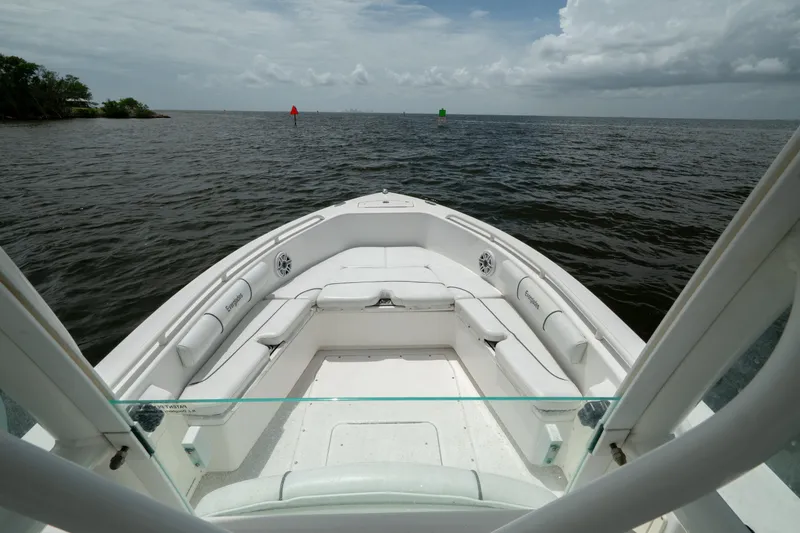 Slide: The Image of 2007 Everglades 243 Center Console boat on open water, featuring spacious seating and clear skies. - 27