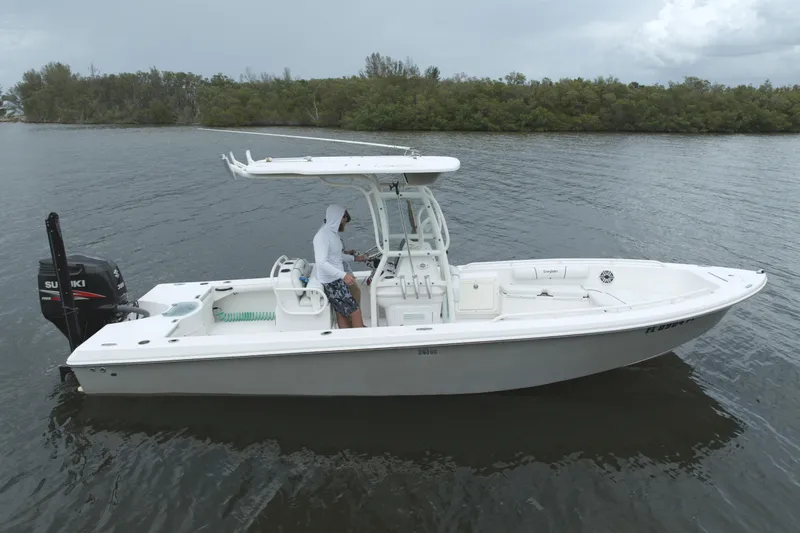 Slide: The Image of 2007 Everglades 243 Center Console boat on calm water, featuring Suzuki outboard motor. - 3
