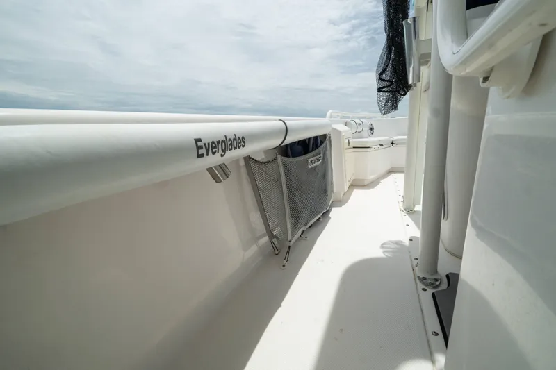 Slide: The Image of 2007 Everglades 243 Center Console boat deck with storage netting and clear sky. - 31
