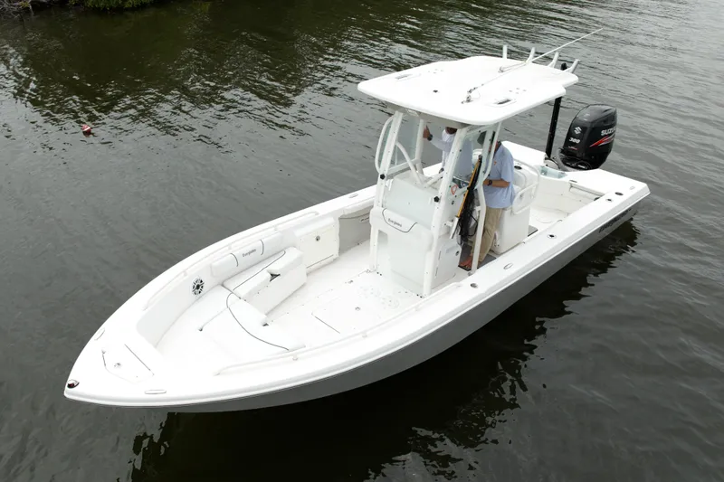 Slide: The Image of 2007 Everglades 243 Center Console boat on calm water, featuring a sleek white design. - 4