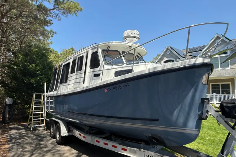 Slide: The Image of 2023 Rosborough 246 Halifax boat on trailer, parked near trees and house. - 9