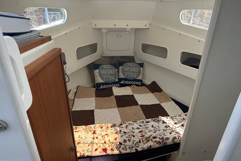 Slide: The Image of Cozy cabin interior of 2023 Rosborough 246 Halifax boat with quilted bedding and "No Wake Zone" pillows. - 28