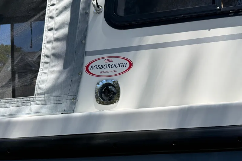 Slide: The Image of 2023 Rosborough 246 Halifax boat exterior with logo and window detail. - 80