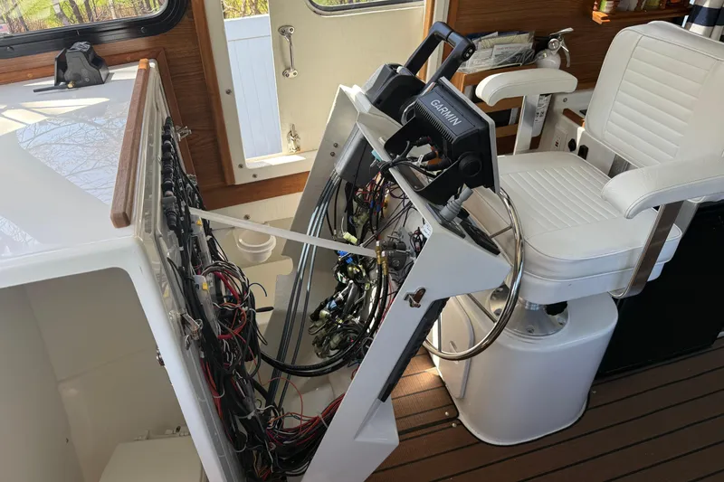 Slide: The Image of Interior of 2023 Rosborough 246 Halifax boat showing helm wiring and white captain's chair. - 25
