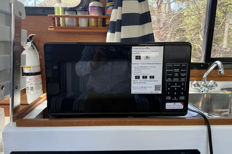 Slide: The Image of Microwave in 2023 Rosborough 246 Halifax boat kitchen, with fire extinguisher and sink nearby. - 18