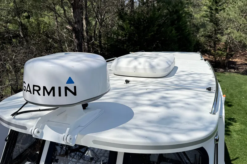 Slide: The Image of 2023 Rosborough 246 Halifax boat with Garmin radar on top, surrounded by trees. - 40