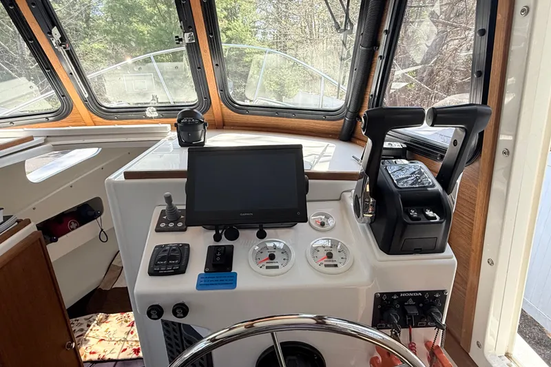 Slide: The Image of 2023 Rosborough 246 Halifax boat cockpit with modern navigation controls and steering wheel. - 21