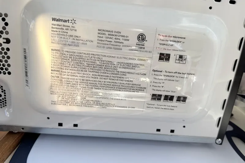 Slide: The Image of Close-up of a microwave oven label with safety instructions and specifications. - 19