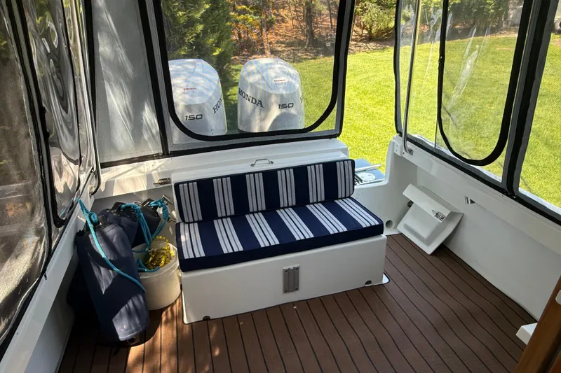 Slide: The Image of 2023 Rosborough 246 Halifax boat interior with striped seating and Honda outboard motors. - 4