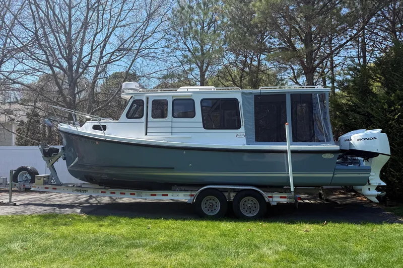 Slide: The Image of 2023 Rosborough 246 Halifax boat on trailer, parked outdoors with trees in background. - 7