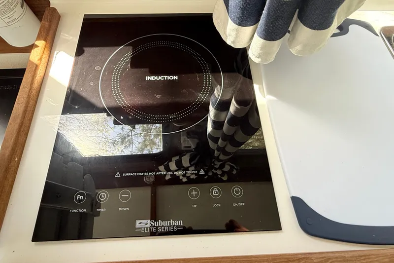 Slide: The Image of Induction cooktop in 2023 Rosborough 246 Halifax boat kitchen, featuring Suburban Elite Series. - 15