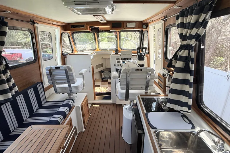 Slide: The Image of Interior of 2023 Rosborough 246 Halifax boat with seating, kitchen, and navigation area. - 11