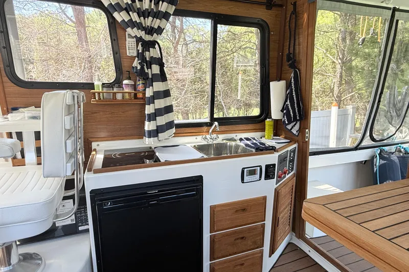 Slide: The Image of Interior of 2023 Rosborough 246 Halifax boat with kitchenette and seating area. - 13