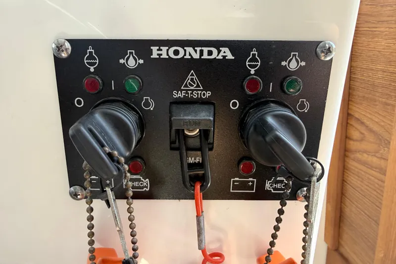 Slide: The Image of Control panel of a 2023 Rosborough 246 Halifax boat with Honda SAF-T-STOP switches. - 49