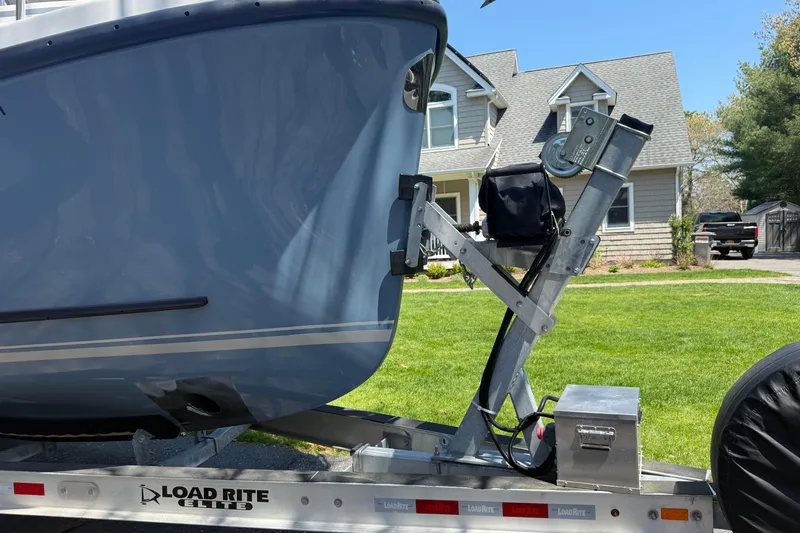Slide: The Image of Rosborough 246 Halifax boat on Load Rite Elite trailer, parked in front of a house. - 68