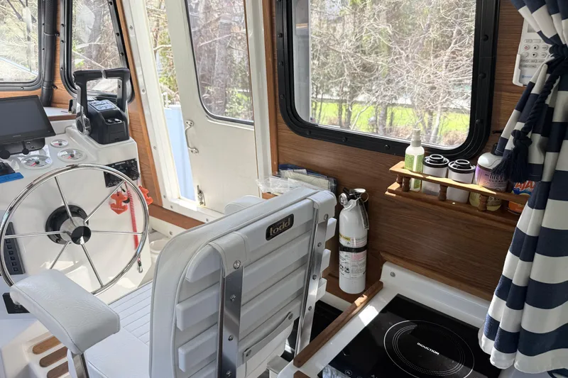Slide: The Image of Interior of 2023 Rosborough 246 Halifax boat with steering wheel and navigation equipment. - 22