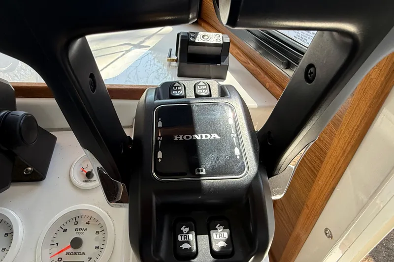 Slide: The Image of Control panel of 2023 Rosborough 246 Halifax boat with Honda throttle and gauges. - 56