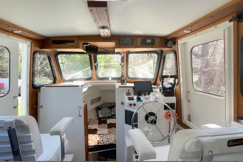 Slide: The Image of Interior of 2023 Rosborough 246 Halifax boat, featuring helm and seating area. - 20