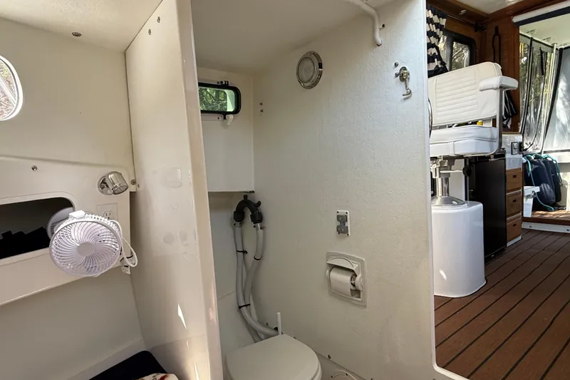 Slide: The Image of 2023 Rosborough 246 Halifax boat interior with compact bathroom and seating area. - 33